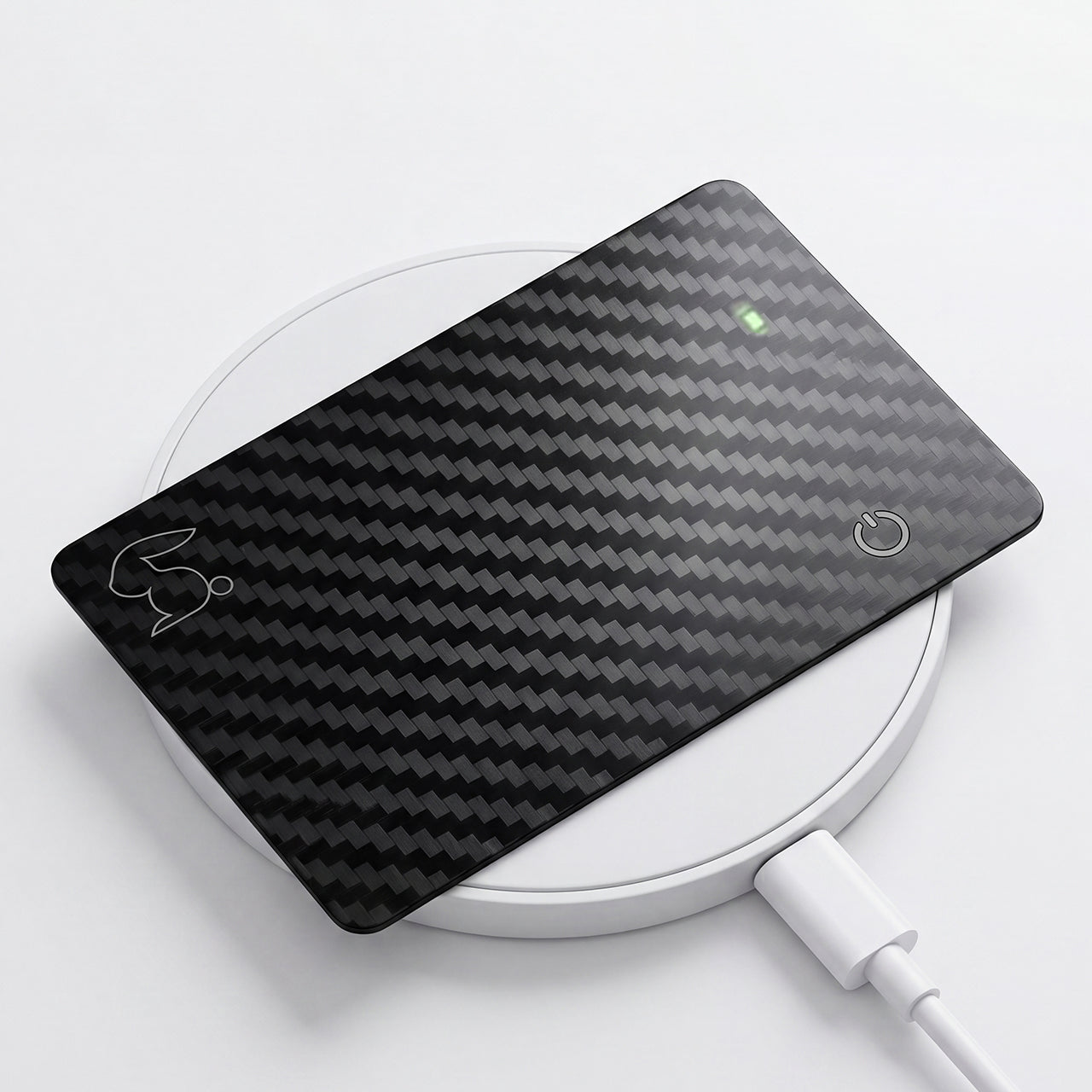 Top Rabbit Tracking Slim Card recharging on a Qi wireless charger — up to 8 months of battery per charge